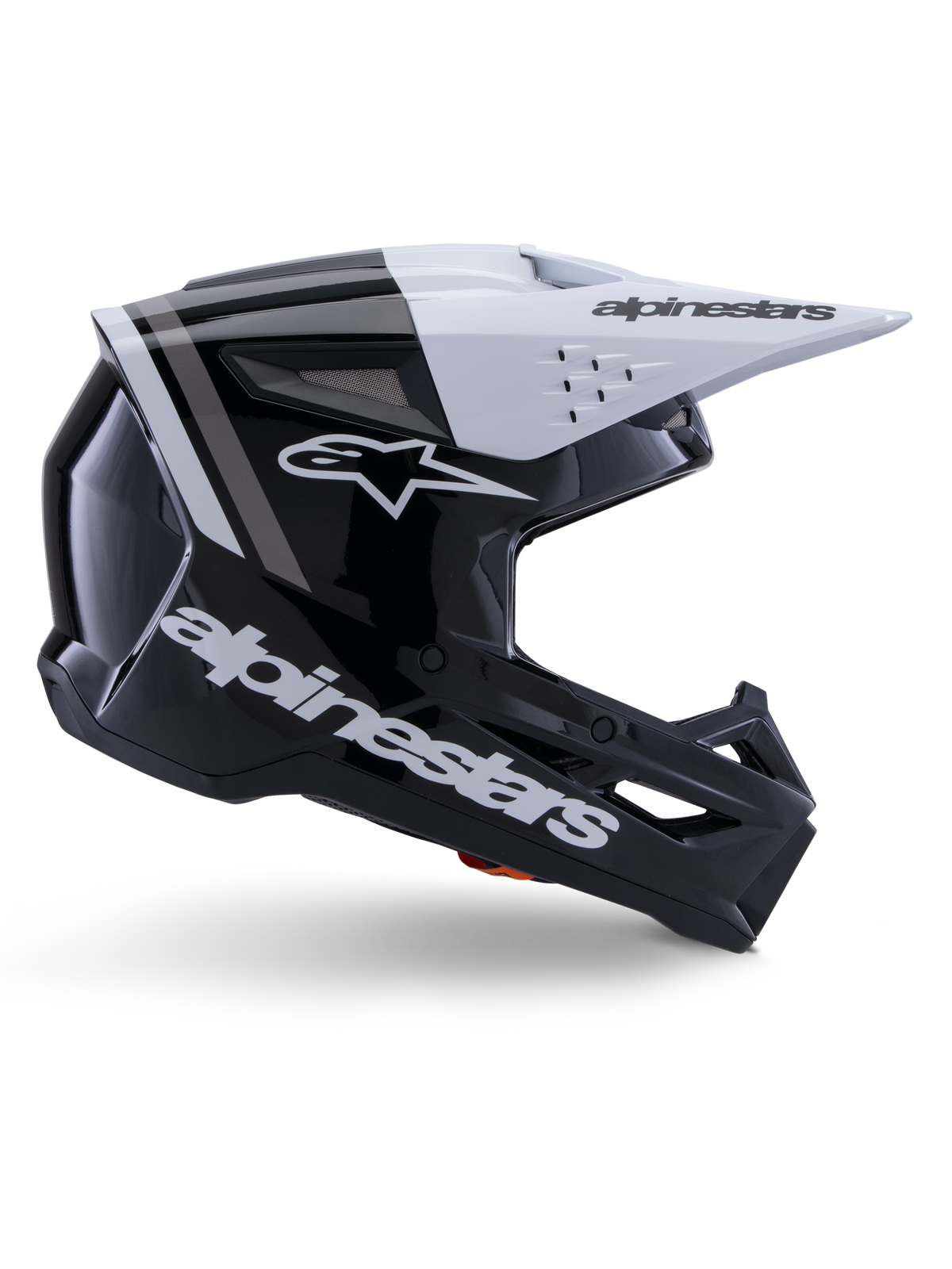 Capacete Alpinestars S-M3 Radium, capacete de motocross off-road, preto, branco e cinzento brilhante, com design aerodinâmico angular e aberturas de ventilação, vista de perfil lateral, acabamento brilhante com riscas cinzentas e viseira branca com logótipo Alpinestars