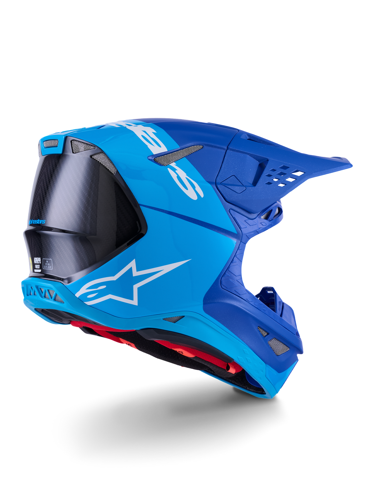 Alpinestars Supertech M10 Flood Helmet, capacete de motocross, azul brilhante e azul marinho com fibra de carbono preta exposta, perfil lateral traseiro com aberturas de ventilação e logótipo branco, forro interior vermelho, design aerodinâmico avançado para performance off-road