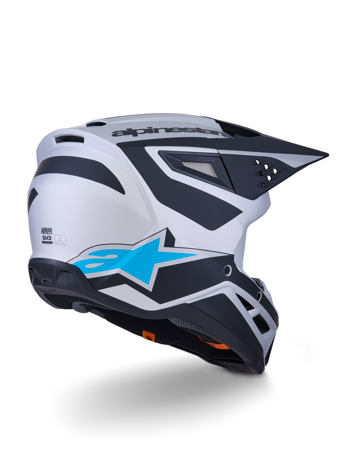 Capacete Alpinestars S-M3 Heat ECE 22.06, capacete de motocross, prateado, azul e preto mate, vista traseira com um grande logótipo de estrela azul e designs angulares pretos, calota aerodinâmica com aberturas de ventilação, proteção de alta performance para corridas todo-o-terreno