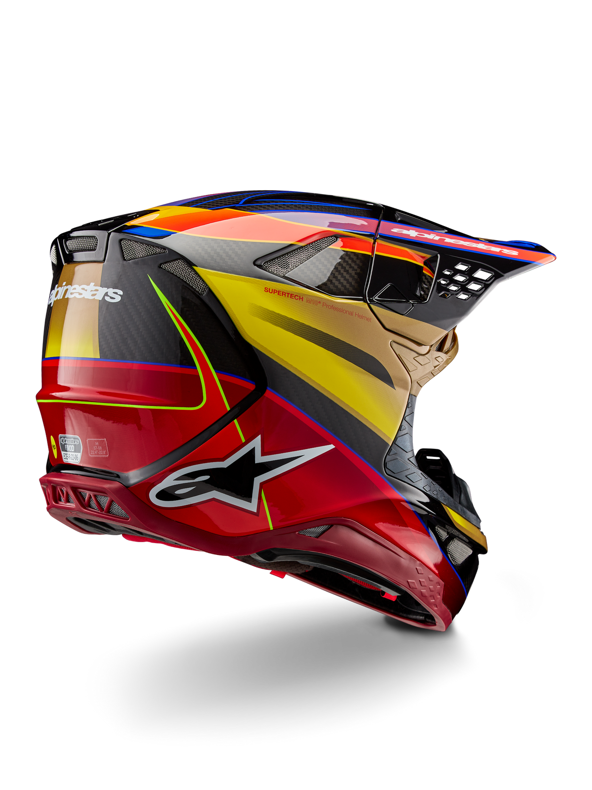 Capacete Alpinestars Supertech M10 Era, capacete de motocross, Amarelo Dourado e Vermelho Rio Brilhante, vista traseira de três quartos mostrando a calota em fibra de carbono com grafismos em vermelho e amarelo, detalhes em azul, perfil aerodinâmico com múltiplas aberturas de ventilação e logótipo Astar em destaque.