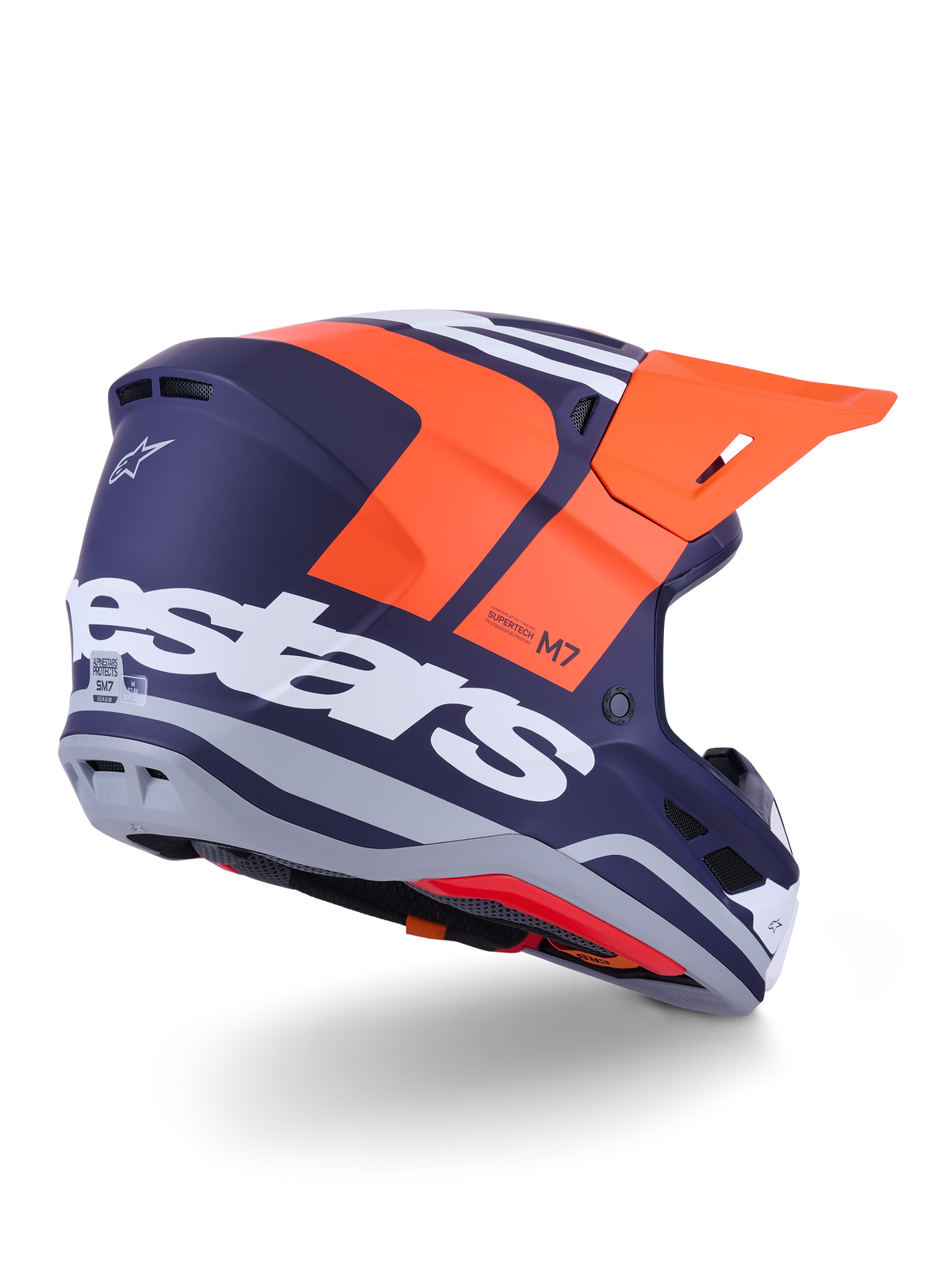 Alpinestars S-M7 Core Helmet, capacete de motocross, laranja e azul mate, vista lateral traseira com a marca Alpinestars em destaque a branco na parte posterior, viseira laranja vibrante, calota aerodinâmica em compósito com detalhes cinzentos, proteção profissional para corridas de todo-o-terreno