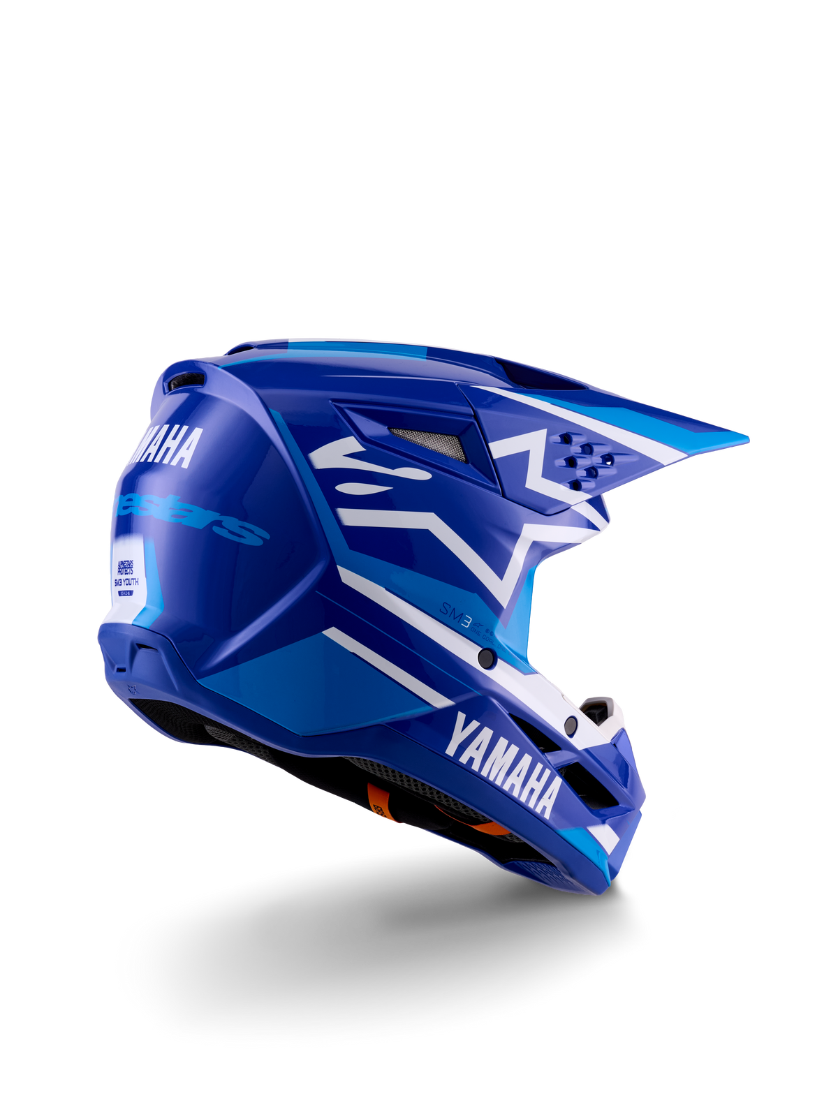 Capacete de motocross Alpinestars Yamaha S-M3 para jovens, azul e branco brilhante, com a marca Yamaha em destaque na lateral e na parte traseira, design aerodinâmico com ventilação posterior, proteção de cabeça para todo-o-terreno numa vista traseira de três quartos