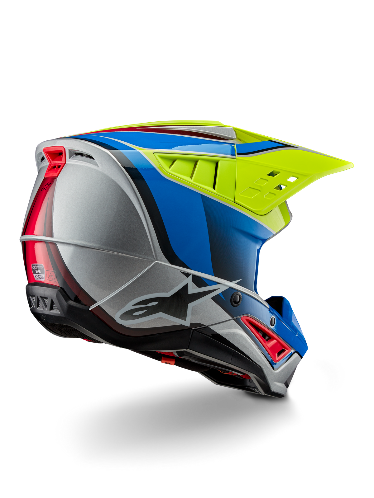 Alpinestars S-M5 Sail Helmet ECE, capacete de motocross, amarelo néon, azul esmalte e prateado brilhante, vista traseira em três quartos exibindo a carcaça termoplástica aerodinâmica, viseira ventilada ampla e aberturas de ventilação integradas para proteção em corridas fora de estrada.