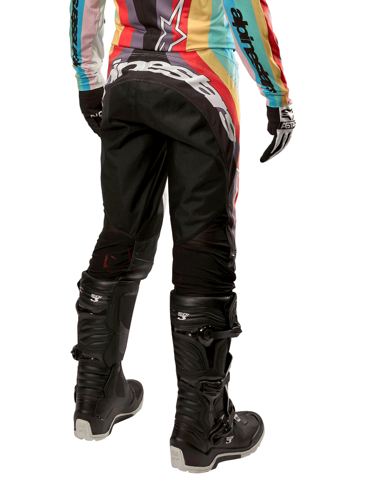 Alpinestars Women Stella 2024 Techstar Pants, Motocross Pants, Black Multicolor, rear view featuring bold white branding across the seat, worn with black Tech 3 boots and a matching multicolor jersey, professional off-road racing apparel.