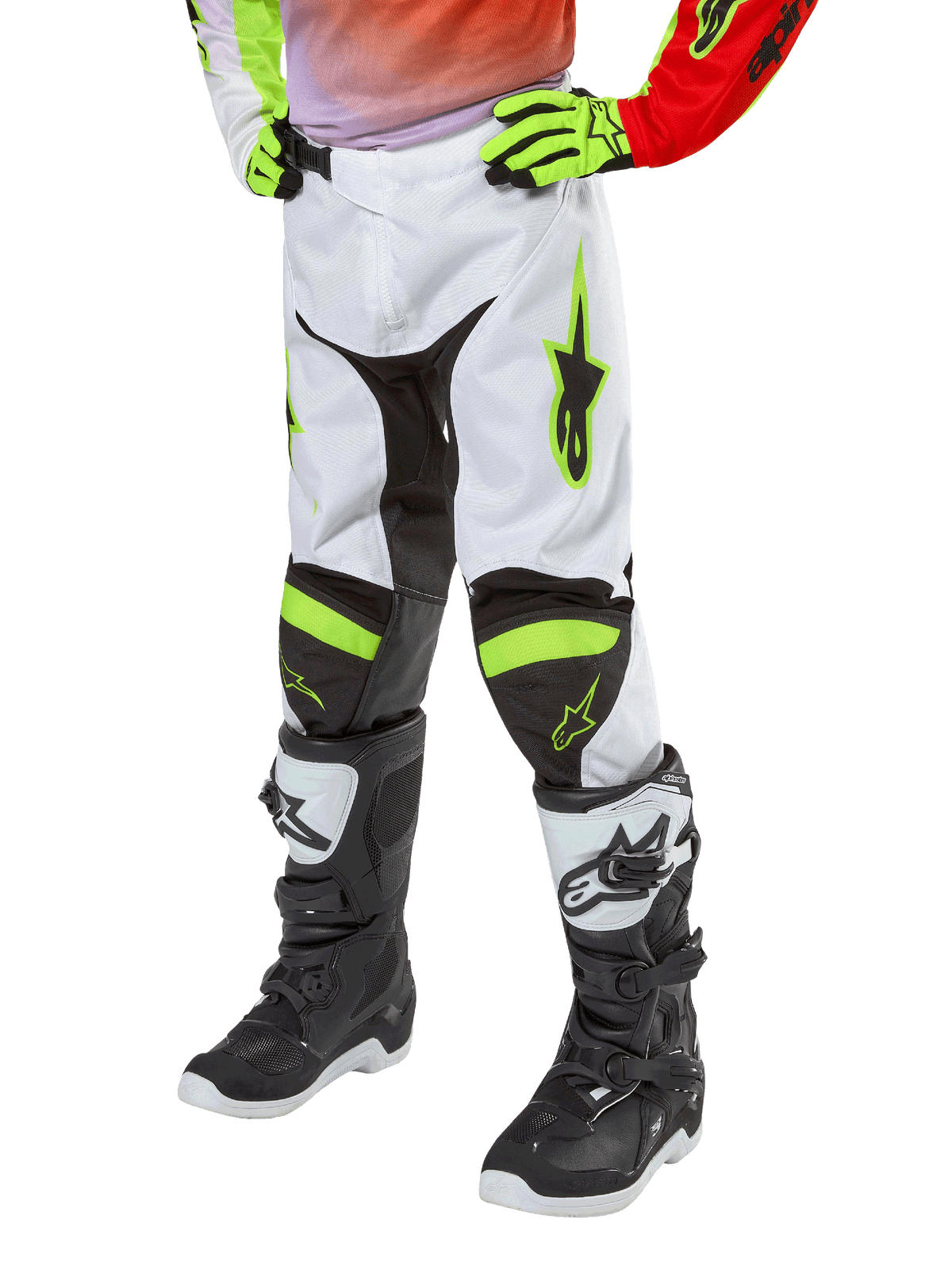 Alpinestars Youth 2024 Racer Lucent Pants, Motocross Pants, White Neon Red and Yellow Fluo, lower-body view featuring black stretch panels and neon accents, worn with black and white racing boots and neon yellow gloves, technical off-road gear for youth