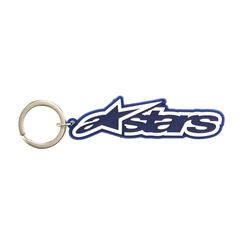 Alpinestars Blaze Key Fob, porta-chaves desportivo, azul e branco, construção em borracha 3D com logótipo da marca e anel de metal, acessório inspirado no desporto motorizado.