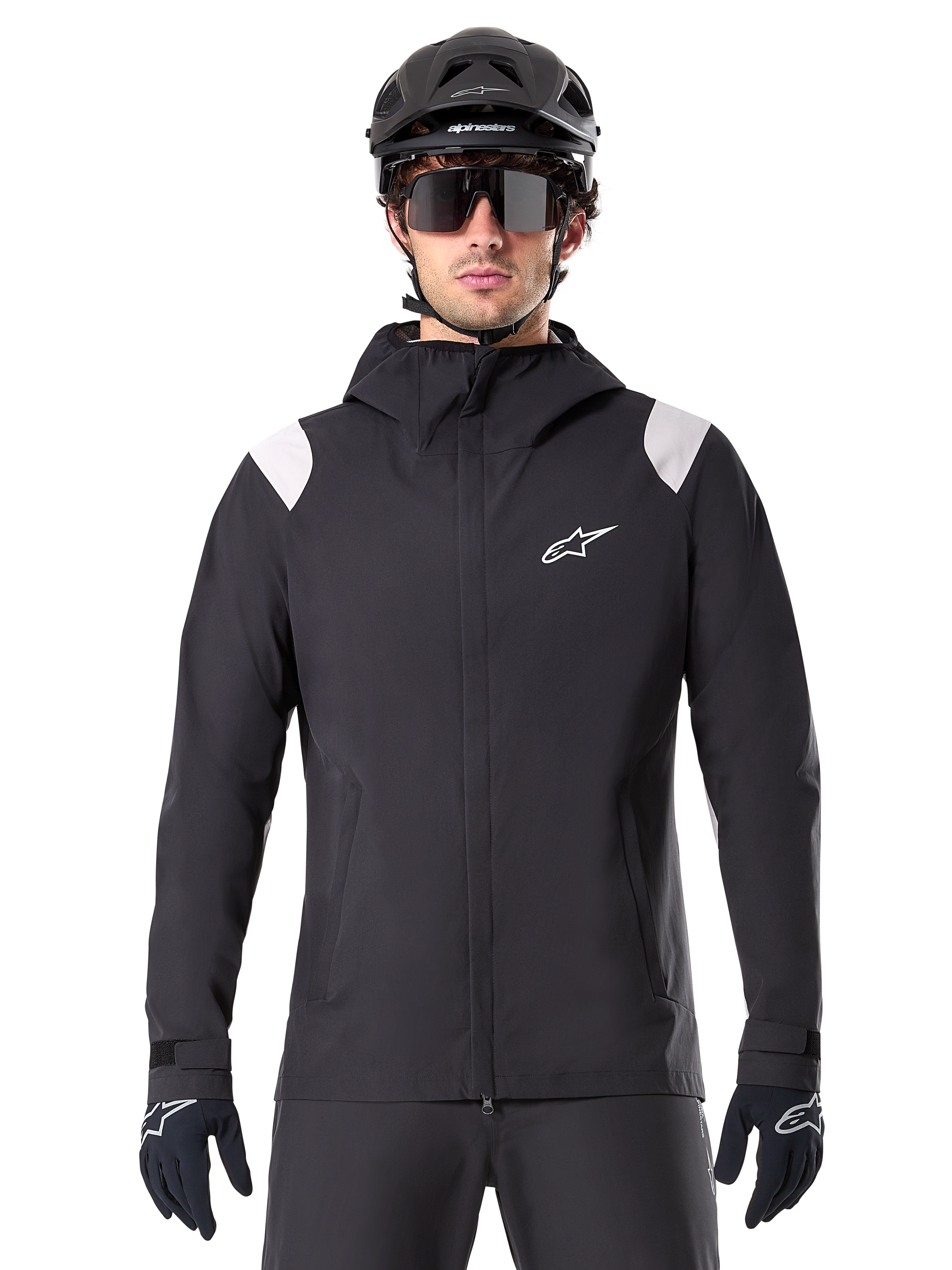 Alpinestars A-Dura Rain Jacket, MTB Rain Jacket, Black with white shoulder panels, worn with black MTB helmet, sunglasses, and gloves, waterproof design with hood and front zipper, sporty outdoor gear for cycling