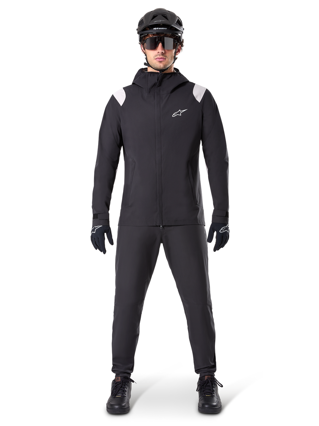 Alpinestars A-Dura Rain Jacket, Mountain Bike Rain Jacket, Black with white shoulder accents and white logo on chest, worn with black pants, black helmet, sunglasses, and gloves, coordinated mountain biking gear for wet weather