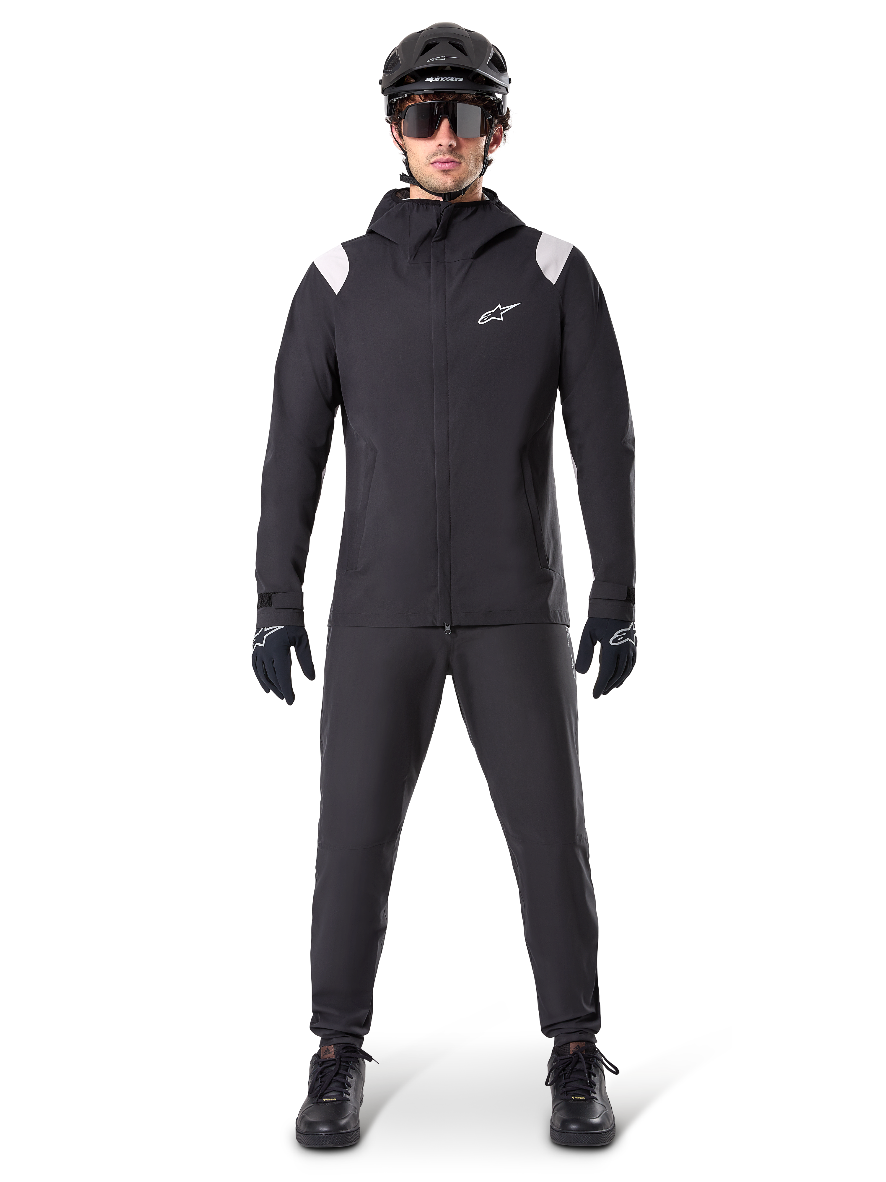 Alpinestars A-Dura Rain Jacket, Mountain Bike Rain Jacket, Black with white shoulder accents and white logo on chest, worn with black pants, black helmet, sunglasses, and gloves, coordinated mountain biking gear for wet weather