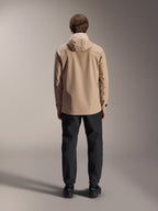 Alpinestars A-Dura Rain Jacket, Light Brown, back view showing hood and adjustable cuffs, worn with black pants, versatile all-weather MTB gear