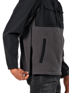 Alpinestars Juncture Hybrid Jacket in Black Gunmetal, side detail view highlighting the side entry zipper and lower welt pocket, mixed-material design with grey canvas fleece and black ripstop overlays, casual motorsport-inspired streetwear