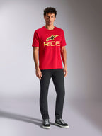Alpinestars Ride 4.0 CSF Tee, Short Sleeve T-Shirt, Red with Hi-Vis Yellow Alpinestars Star and Ride Logo, worn by model with black pants and sneakers, Casual Motorsport Sportswear