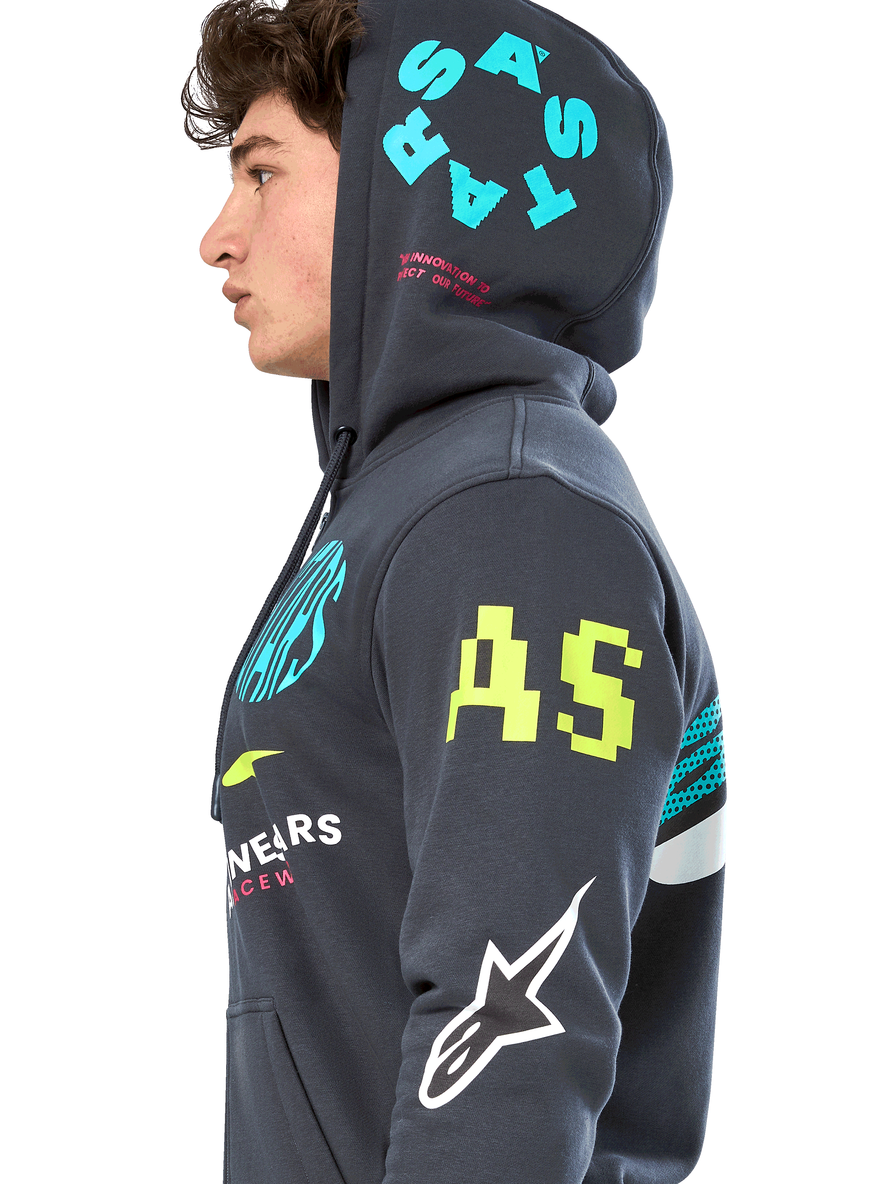 Alpinestars Variegate Hoodie, Gunmetal gray zip-front fleece, side profile of model, multi-logo artwork in neon yellow, light blue, and white, features 'AS' branding on sleeve and 'STARS' on hood, casual motorsport-inspired streetwear