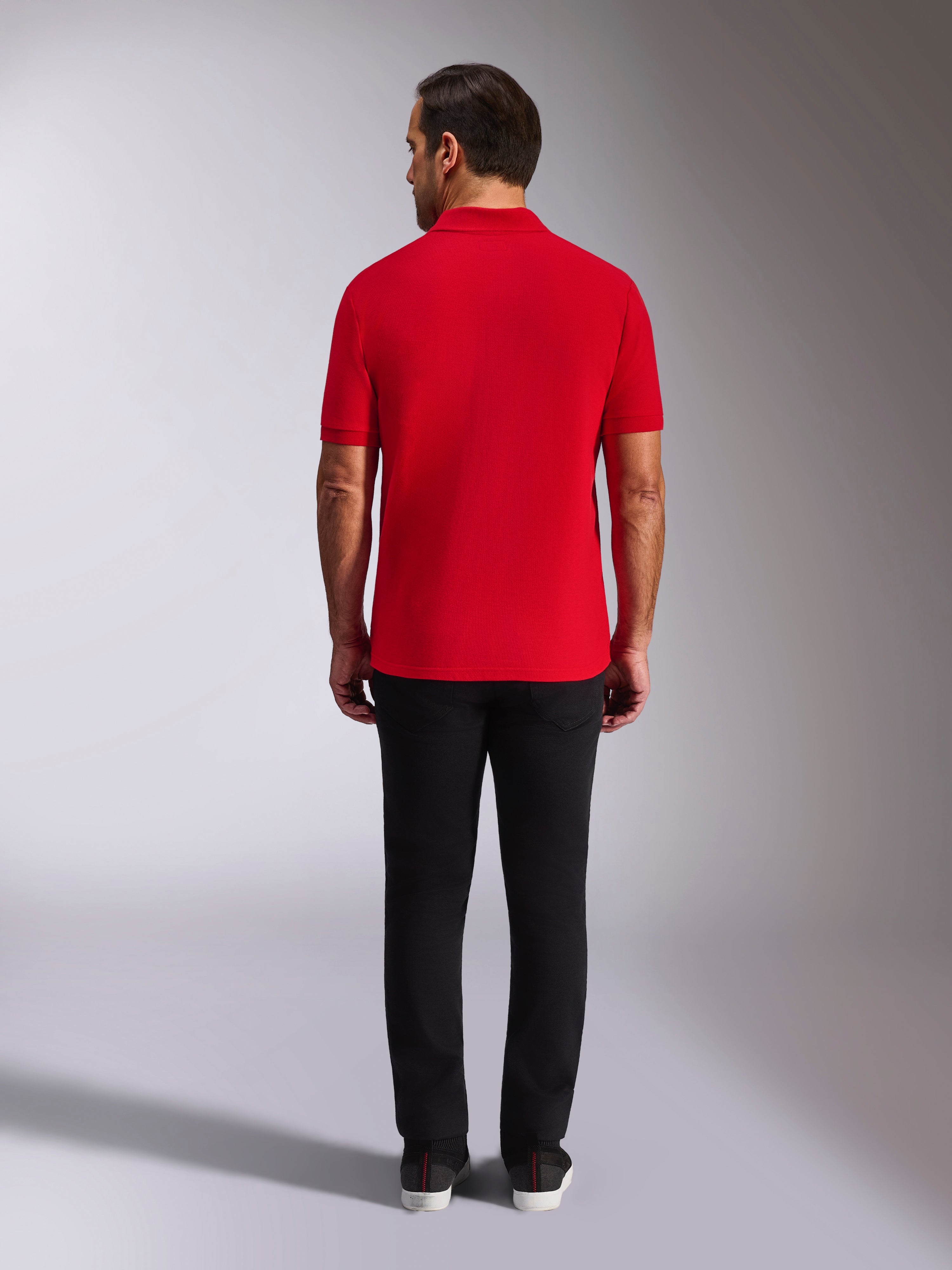 Alpinestars Endeavor Classic Polo, Red Pique Polo Shirt, back view, worn with black pants, casual motorsport streetwear featuring ribbed collar and sleeve cuffs
