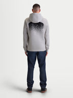 Alpinestars camisola com capuz Obsessed, camisola de fleece para homem em cinzento cimento e preto, vista traseira com um grande gráfico MX em gradação, vestuário casual inspirado no desporto motorizado com capuz e acabamentos canelados.