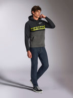 Alpinestars Parallel Hoodie, casual streetwear, color-blocked black and gunmetal grey, neon yellow Alpinestars word logo on chest, white Astars logo, drawstring hood, worn with dark jeans and sneakers