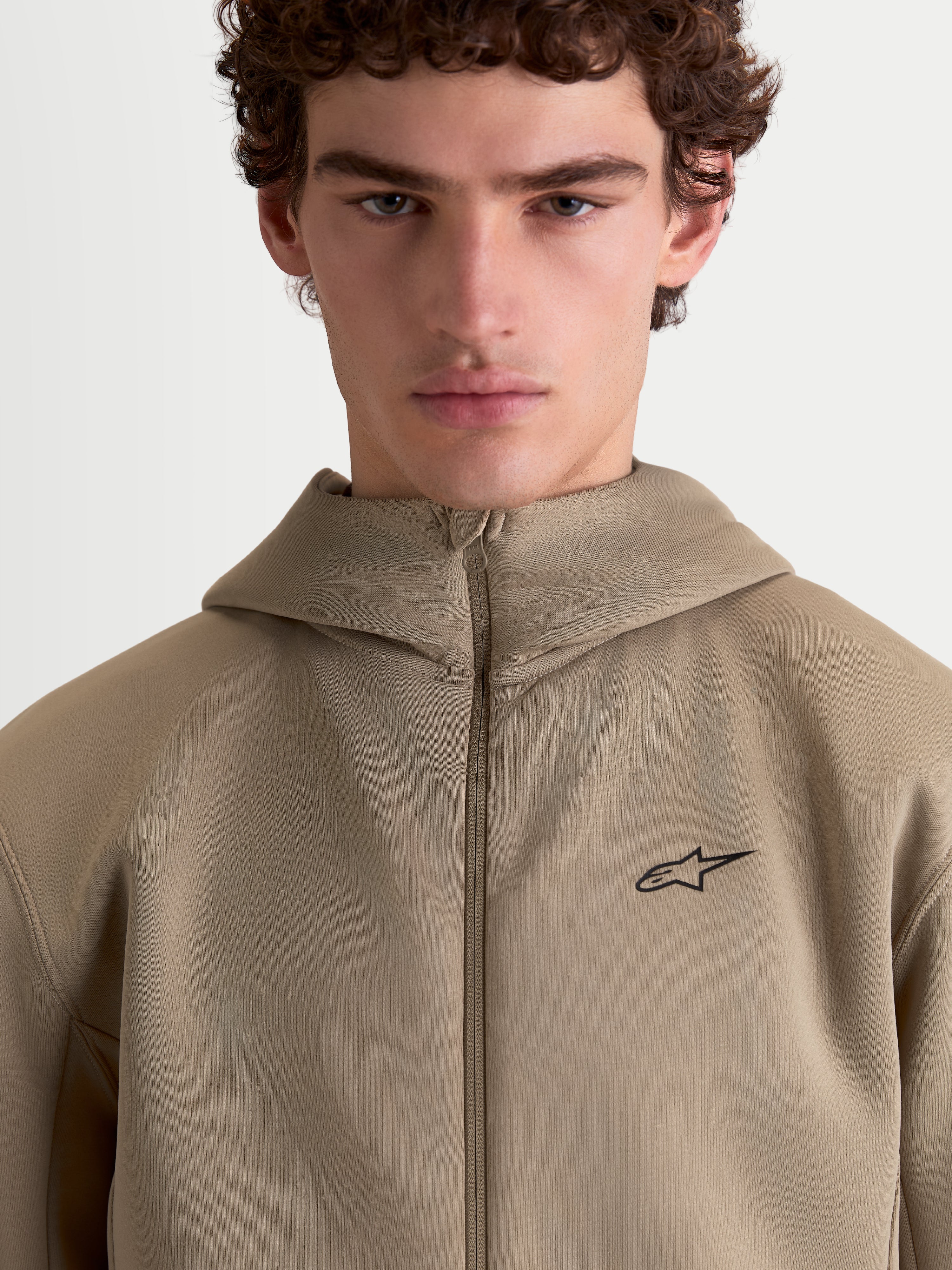Alpinestars Cypher Hoodie, Sportswear Full-Zip Fleece for Men and Women, Putty Beige, featuring a high-neck hood, technical tri-blend double-face fabric, and a minimalist Alpinestars logo on the chest.