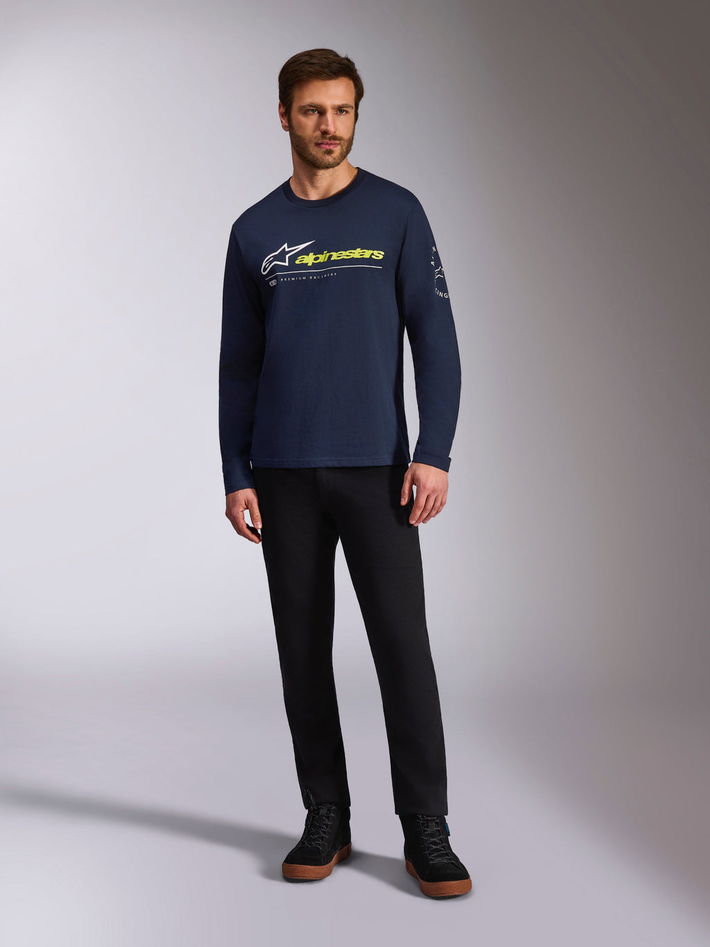 Alpinestars Mandatory CSF Tee, Long Sleeve T-Shirt, Navy Blue, White Astars Logo with Neon Yellow Word Logo, worn by a model with black pants and black sneakers, casual motorsport streetwear