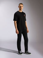 Alpinestars Overhang Oversized CSF Tee, Short Sleeve T-Shirt, Black, featuring a front white and red Astars logo, worn by a model with black pants and sneakers, oversized casual streetwear design