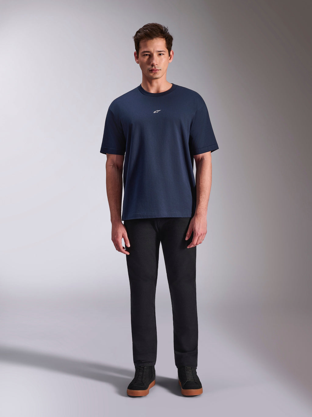 T-shirt Alpinestars Focused Oversized CSF, camisola de manga curta azul marinho, logótipo Astars branco pequeno no peito, corte oversized, combinada com calças e sapatilhas pretas, streetwear casual de motorsport