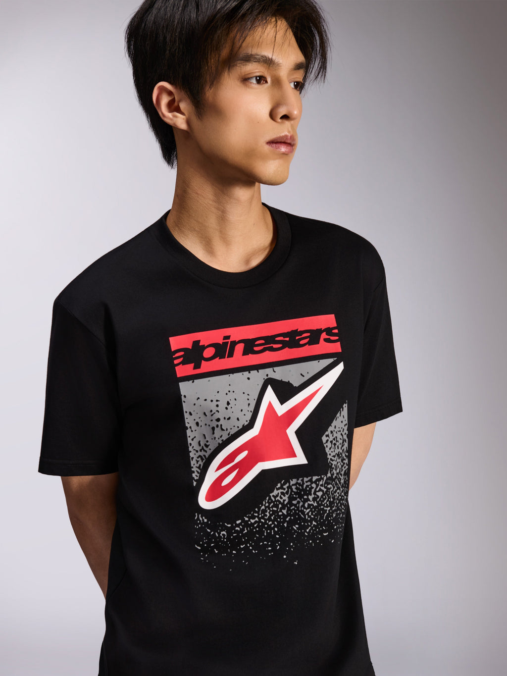 Alpinestars Noka CSF Tee, Short Sleeve T-Shirt, Black, featuring a red branding block and large red and white Astars logo with a grey textured background, Casual Motorsport Streetwear