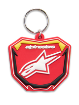 Alpinestars Plate Keyfob, porta-chaves moldado em 3D, vermelho, amarelo e preto, logótipo Alpinestars e símbolo de estrela Astars em branco, argola metálica prateada, design de placa MX inspirado no motociclismo