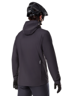 Alpinestars A-Dura Thermal Jacket, Black, back view, worn with a black mountain bike helmet and gloves, features a small white Astars logo on the lower back, lightweight insulated cycling jacket