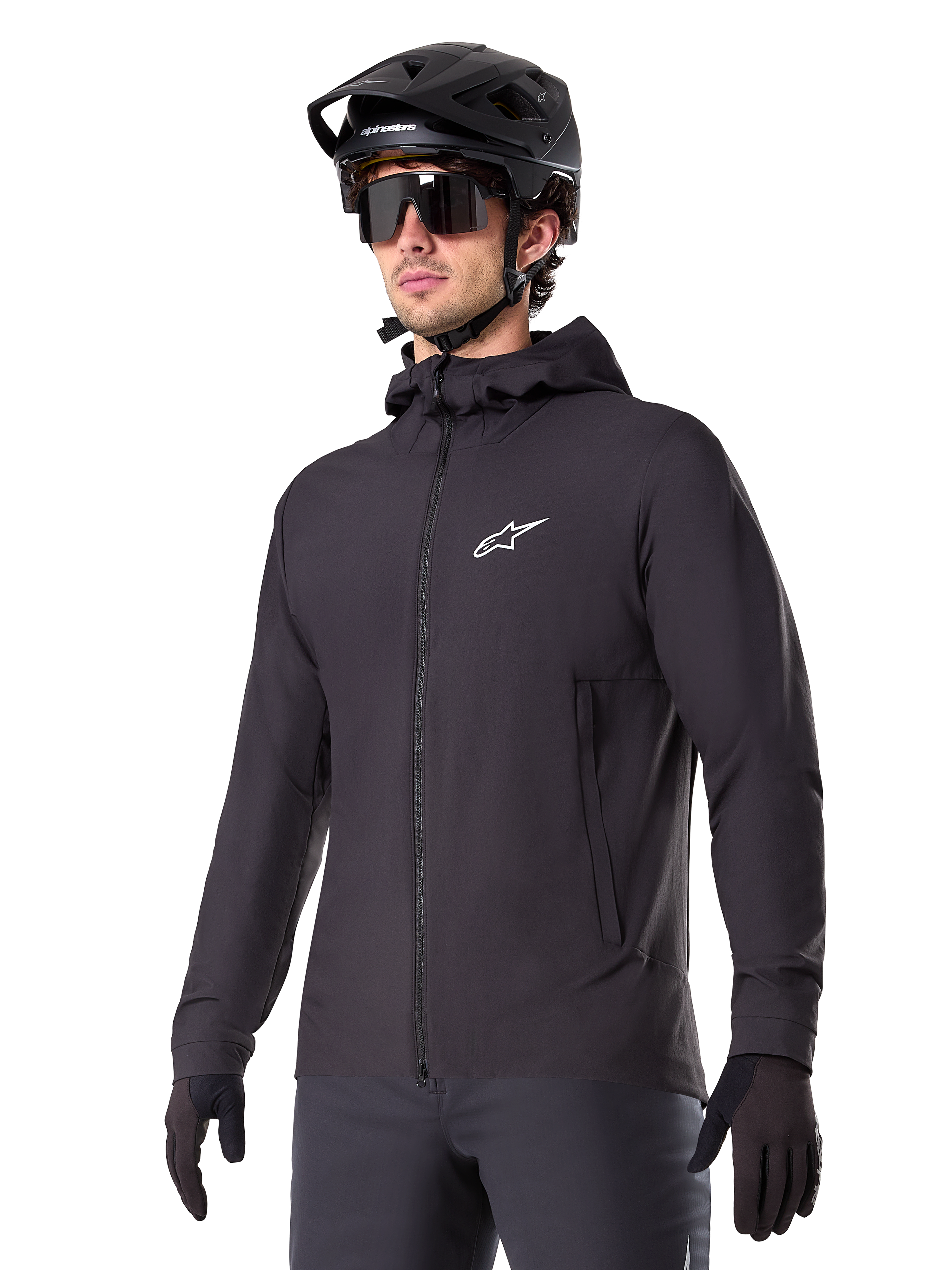 Alpinestars A-Dura Thermal Jacket, Black Cycling Jacket, hooded design with front zipper, white star logo on chest, worn with black mountain bike helmet and gloves, sporty performance gear for cold weather trail riding
