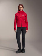 Alpinestars Stella A-Dura Elite Waterproof Jacket, Women's MTB Jacket, Red Fluo, worn with black pants and shoes, featuring a high-neck hood and white Alpinestars logo, technical mountain bike apparel