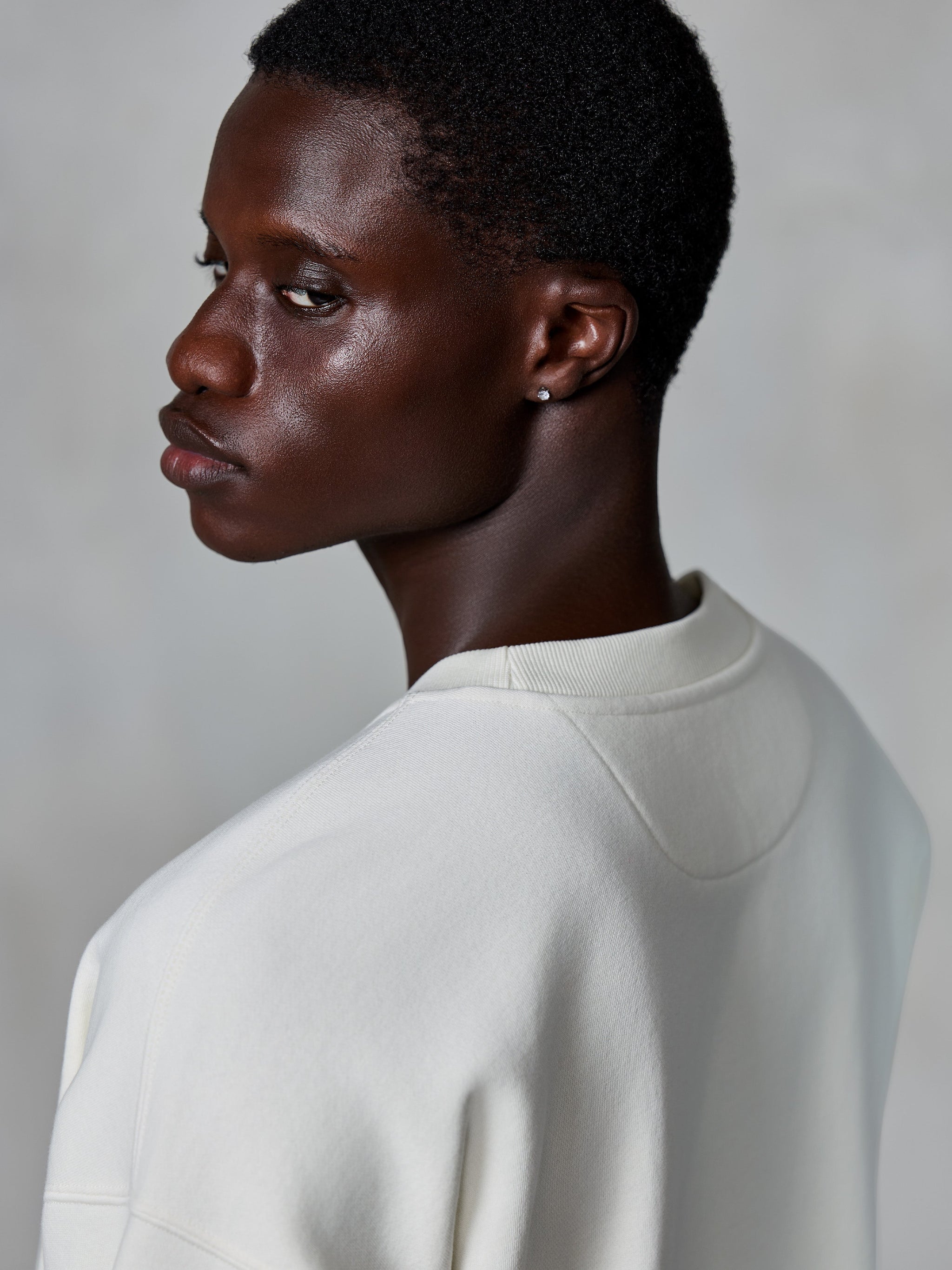 Alpinestars Essentials Ageless Crew, Crewneck Sweatshirt, Off White, close-up back view on model showing the ribbed neckline and premium fleece texture, casual lifestyle streetwear