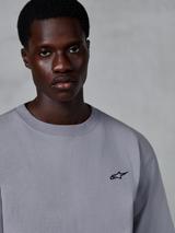 Alpinestars Essentials Ageless SS Tee, Short Sleeve T-Shirt, Silver, featuring a small black star logo on the chest, worn by model, casual lifestyle streetwear