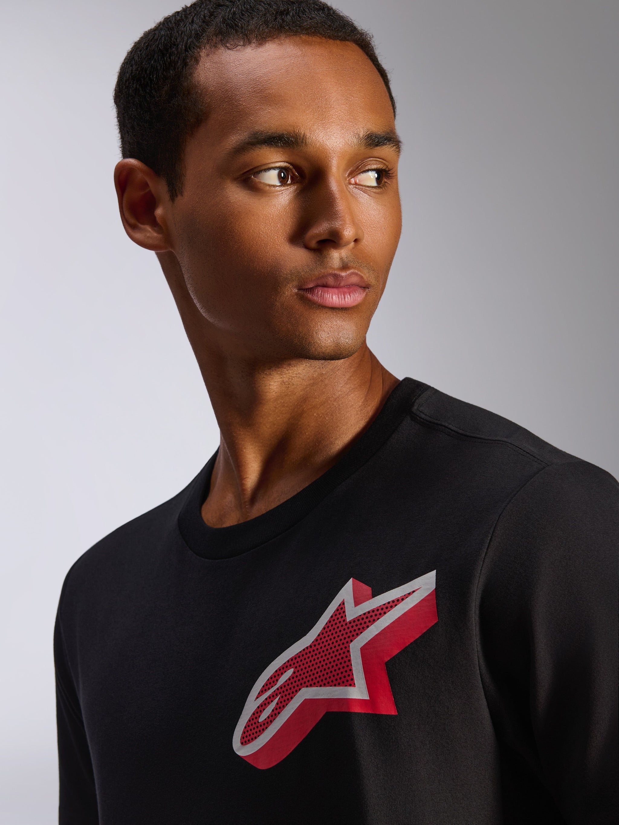 Alpinestars Shaded CSF Tee, Short Sleeve T-Shirt, Black, featuring a red and white gradient foil Astars logo on the chest, casual motorsport-inspired apparel worn by male model