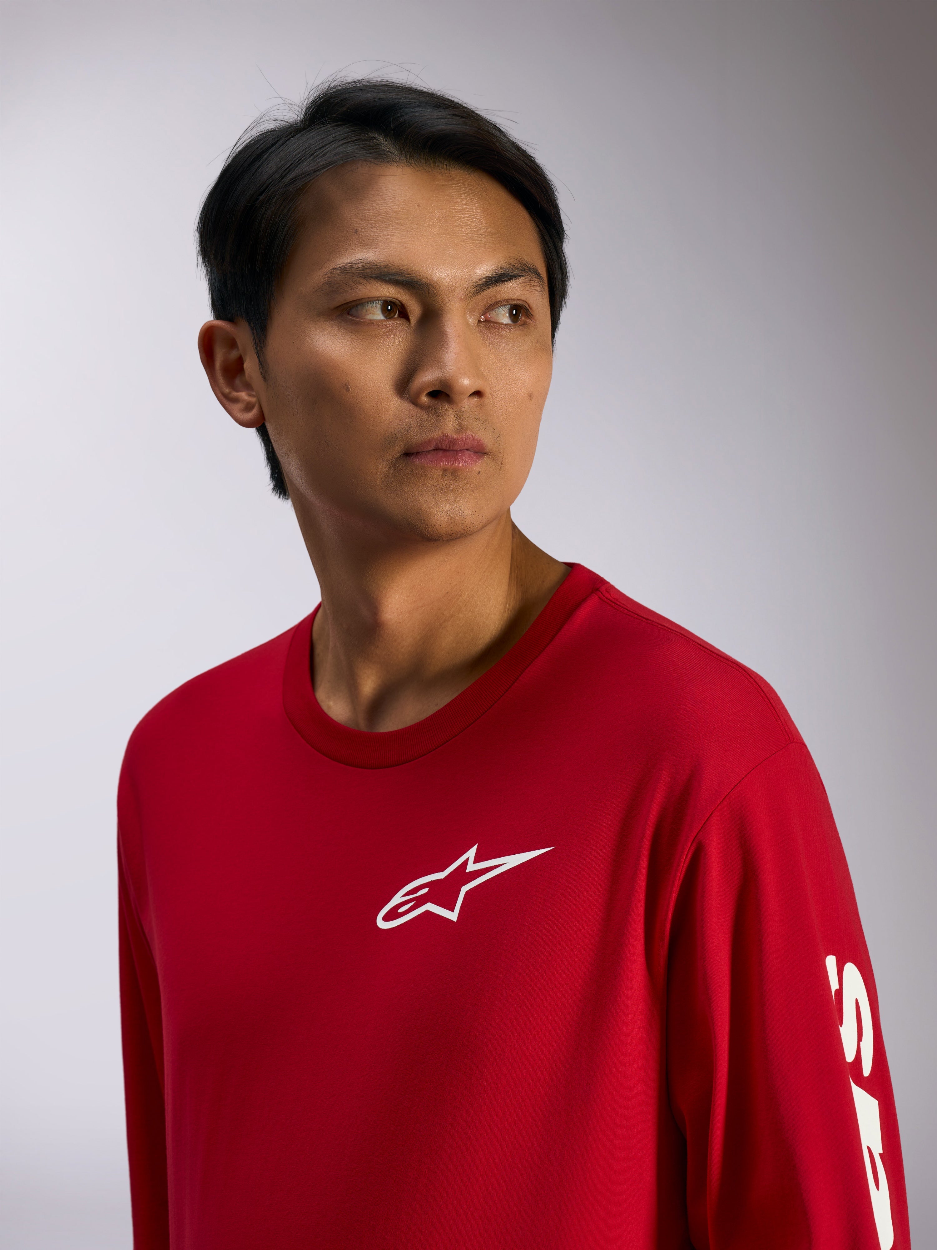 Alpinestars Trackside CSF Tee, t-shirt de manga comprida, vermelha com logótipo Alpinestars branco no peito e letras na manga, streetwear casual de desportos motorizados, retrato lifestyle
