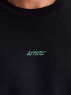 Alpinestars Guise Oversized Crew, Sportswear Fleece Pullover, Black with Teal embroidered ASTARS word logo, close-up of ribbed crew neck and chest detail, premium cotton and recycled polyester construction for everyday lifestyle comfort