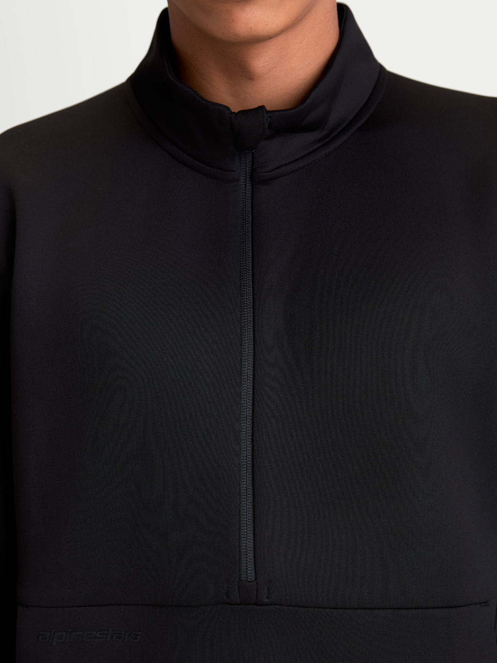 Alpinestars Apera Half-Zip Sweatshirt, Black Sportswear Pullover, close-up detail of the front half-zip closure and high collar, on-model view, featuring tri-blend fleece and a tonal Alpinestars logo for a clean motorsport-inspired look.
