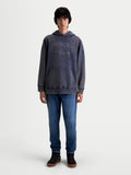 Alpinestars Camisola Com Capuz Infinite Washed Oversized, camisola casual de estilo sportswear vestida por um modelo, azul com acabamento snow-wash, bolso canguru frontal e logótipo Alpinestars bordado no peito, silhueta oversized e ajuste relaxado.