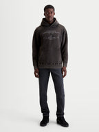 Alpinestars Camisola Com Capuz Infinite Washed Oversized, camisola de fleece em preto lavado para homem, com acabamento snow-wash, bolso canguru e bordado técnico no peito. Modelo veste peça com corte relaxado e oversized para estilo casual sportswear.