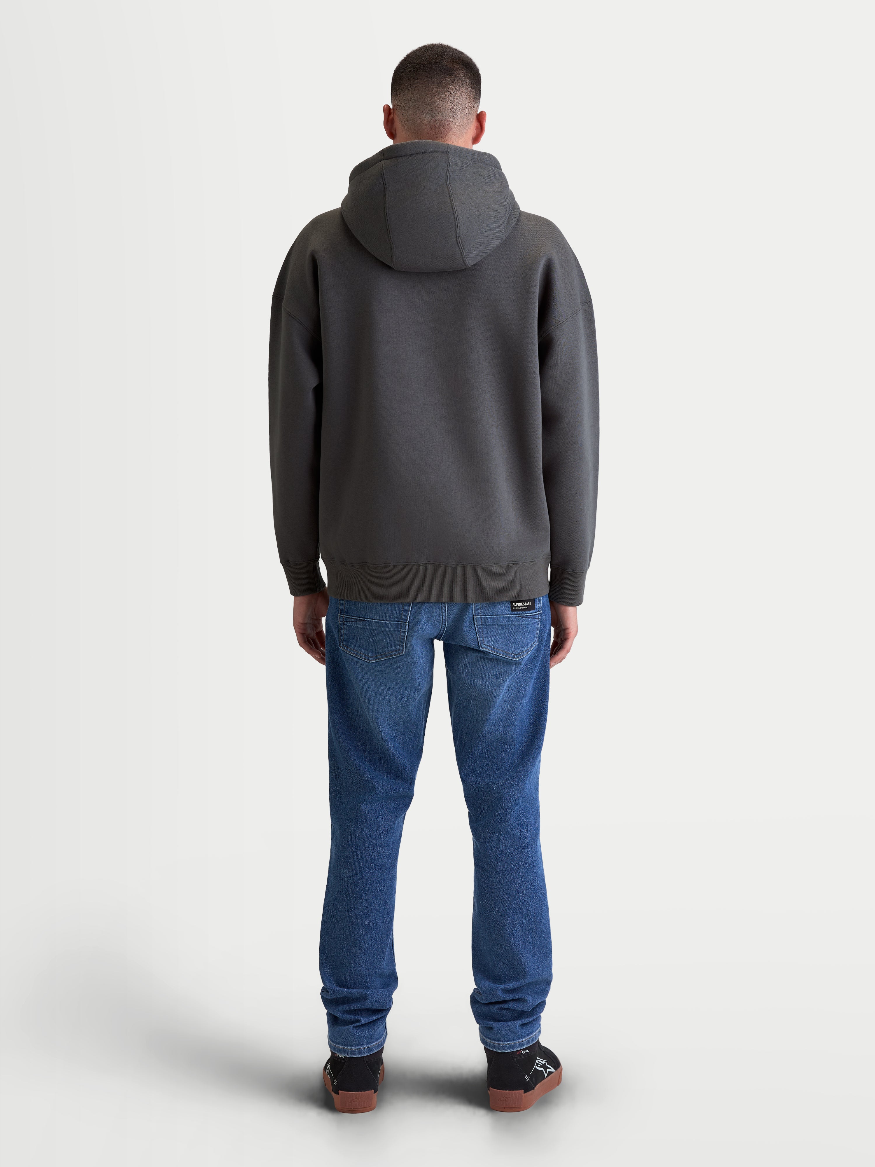 Alpinestars camisola com capuz Prelude Oversized, hoodie de sportswear em fleece para homem, cinzento escuro, vista traseira mostrando o corte descontraído, capuz com forro e acabamentos canelados.