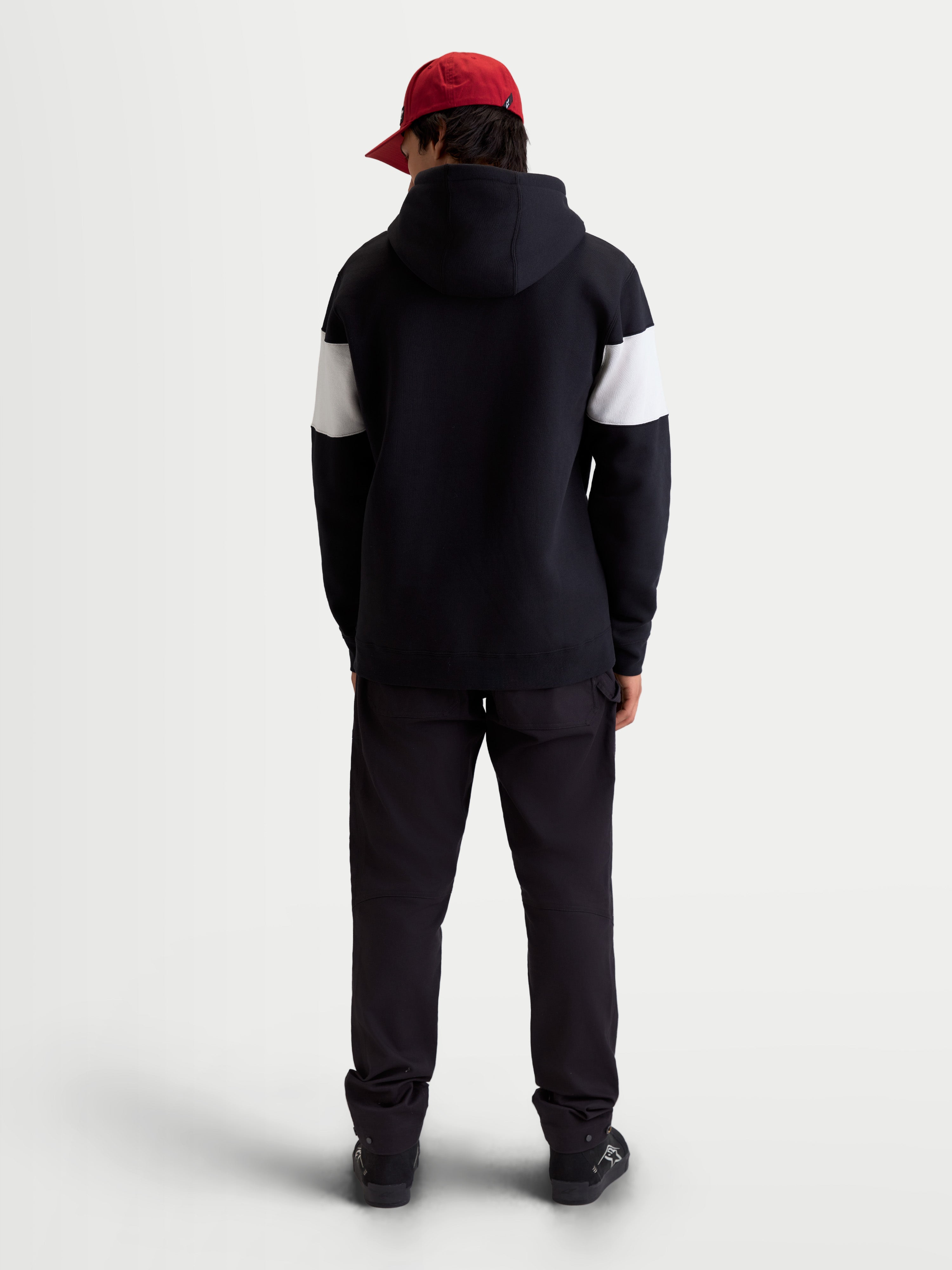 Alpinestars Cubic Hoodie, Unisex Sportswear Pullover Fleece, Black and White Color-Blocked Sleeves, Back View on Model, Premium Cotton Blend Construction, Casual Off-Bike Apparel.