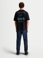 Alpinestars T-Shirt Post Oversized CSF, t-shirt de manga curta unissexo, preta com gráficos verde-azulado nas costas, lema One Goal. One Vision. e logótipo Astars World Wide, ajuste oversized, sportswear em mistura de algodão penteado.