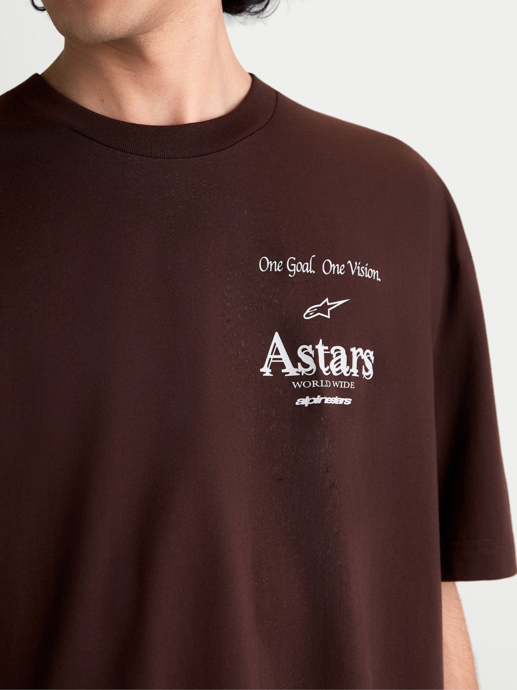 Alpinestars T-shirt Post Oversized CSF, t-shirt de manga curta castanha, pormenor do gráfico branco no peito com One Goal. One Vision. e logótipo Astars, sportswear casual em mistura de algodão e poliéster.