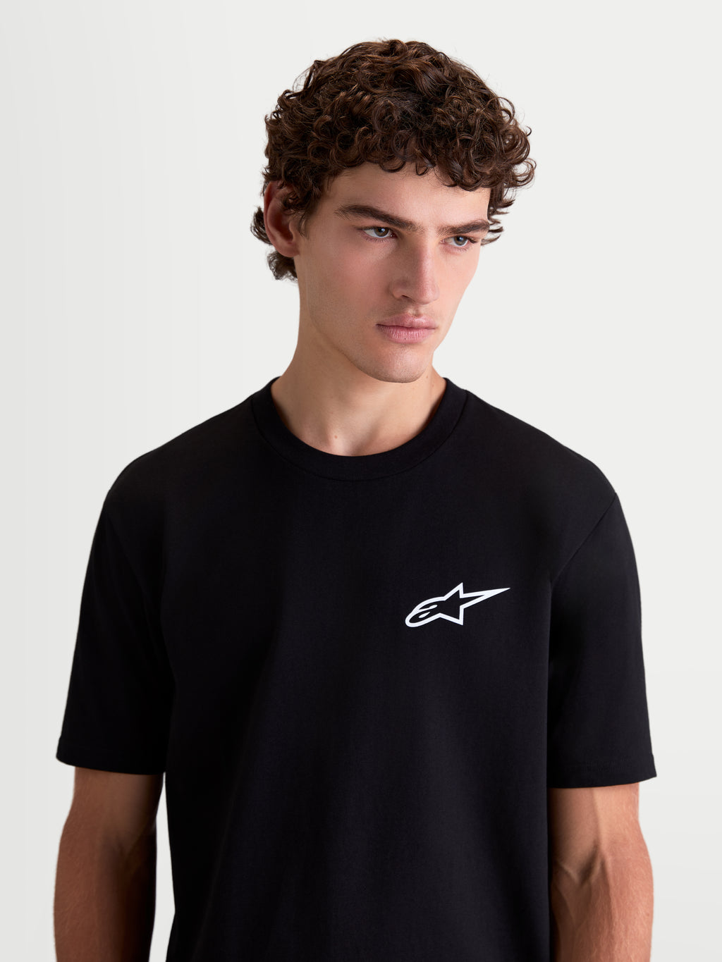 Alpinestars Combo Back CSF Tee, Short Sleeve Sportswear T-Shirt, Men's on-model front view, Black and White, cotton-poly blend featuring a white Astars logo graphic on the chest.