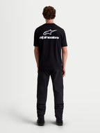Alpinestars Combo Back CSF Tee, Short Sleeve Sportswear T-Shirt, Black and White, featuring a large white Astars logo and text graphic on the back, premium cotton-poly blend for casual motorsport-inspired style, back view on model.