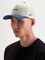 Alpinestars Boné County Canvas, boné desportivo sportswear, em bege e azul, worn by a model, featuring curved bill and embroidered Astars logo