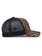Alpinestars Thicket Realtree boné trucker, padrão camuflado e preto, vista lateral com aba curva e malha traseira respirável.