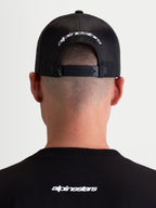 Alpinestars Boné Trucker Meteorite, boné de sportswear com traseira em malha, preto e branco, com fecho snapback ajustável e logótipo Alpinestars bordado a branco na parte traseira.