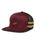 Alpinestars Backline Trucker Hat, boné de malha bordô e preto, logótipo de estrela amarelo e gráfico heritage "Since 1963", copa estruturada com pala plana, riscas laterais amarelo mostarda