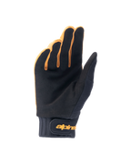 Luvas Alpinestars A-Dura, luvas de bicicleta de montanha, dourado escuro e preto, vista da palma apresentando material em camurça sintética, punho de neoprene com tira de pulso em gancho e laço dourada, concebidas para aderência e mobilidade no ciclismo.