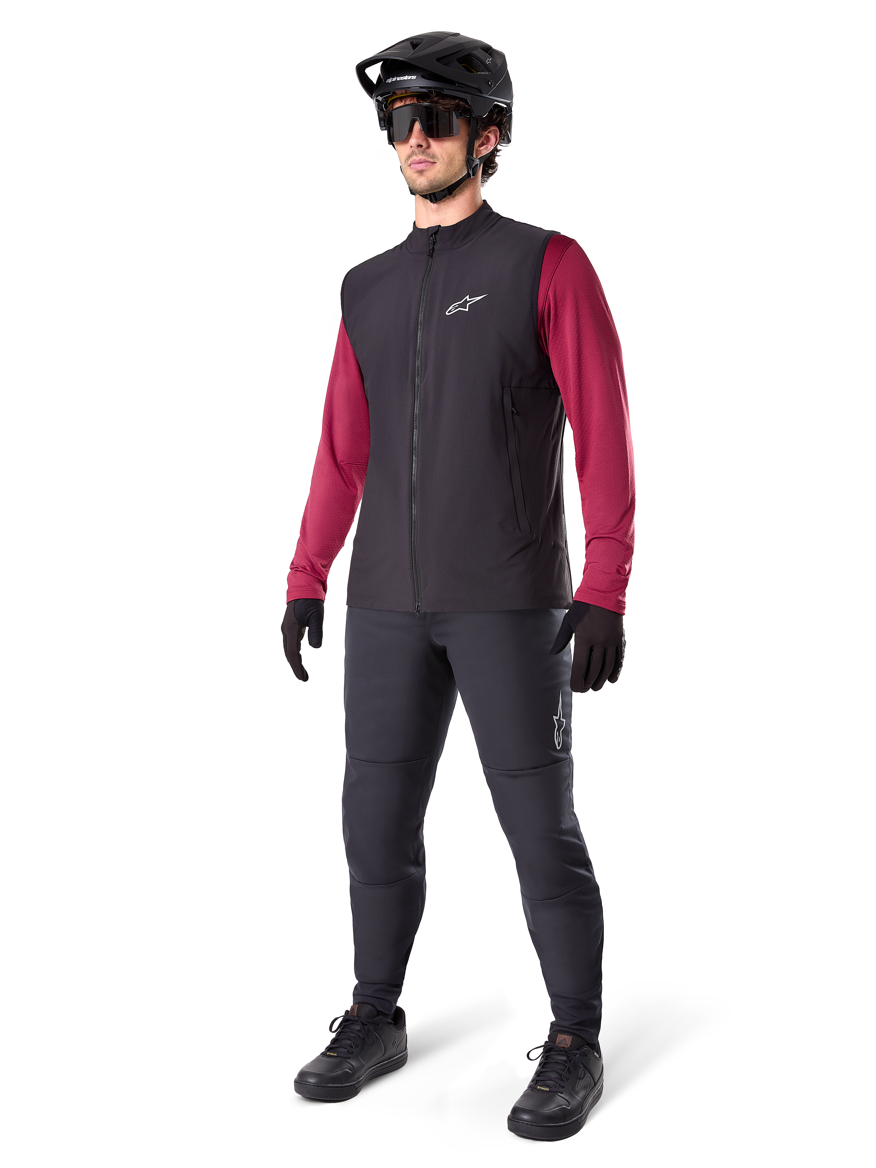Alpinestars A-Dura Thermal Vest, Black cycling vest, worn by a rider over a maroon long-sleeve jersey and black pants, featuring a black MTB helmet and gloves, designed for cold-weather mountain biking