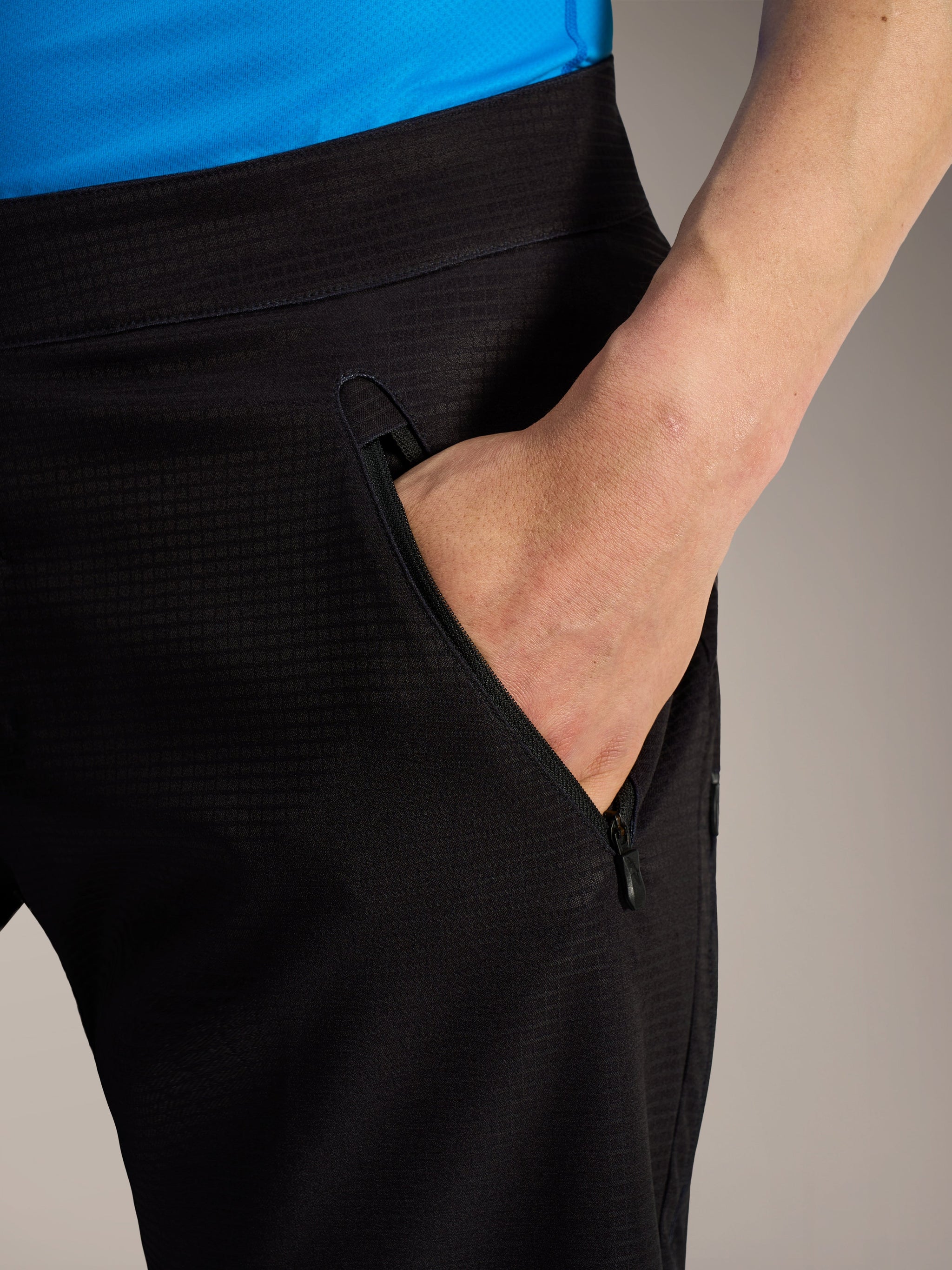Black A-Dura Elite Flex Shorts showing a zippered side pocket and durable ripstop stretch fabric for mountain biking.